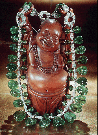 Tumbled Emerald Necklace On Wooden Buddha Figure