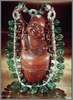 Tumbled Emerald Necklace On Wooden Buddha Figure